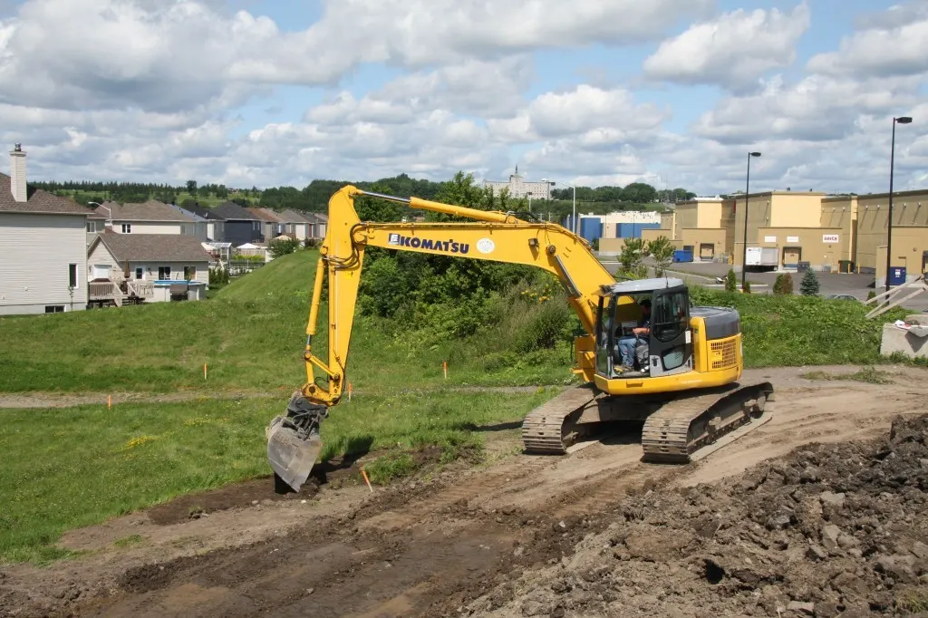 Excavator preparing a lot